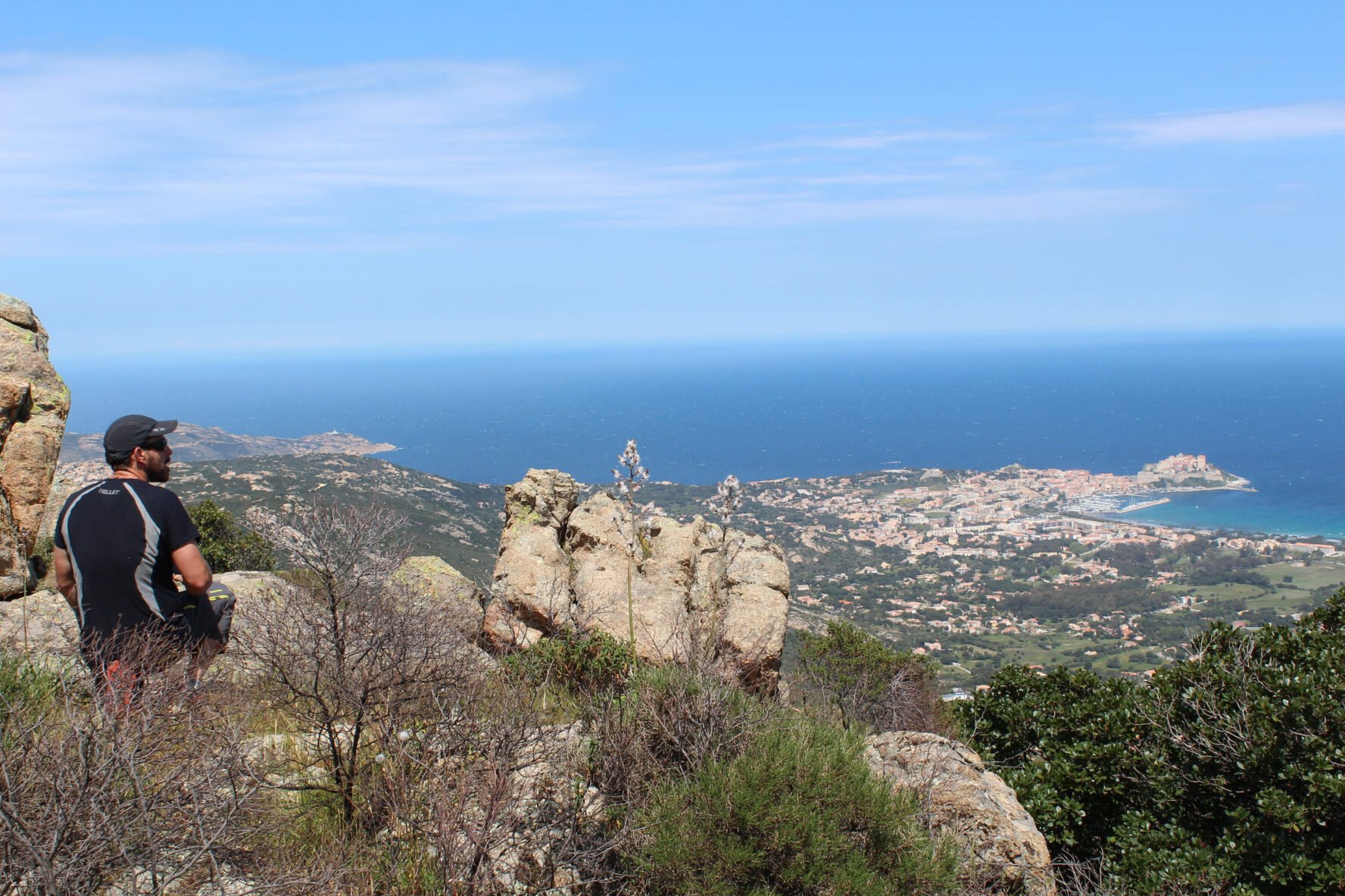Hiker admiring a panoramic view of Calvi on the Corsica walking holidays
