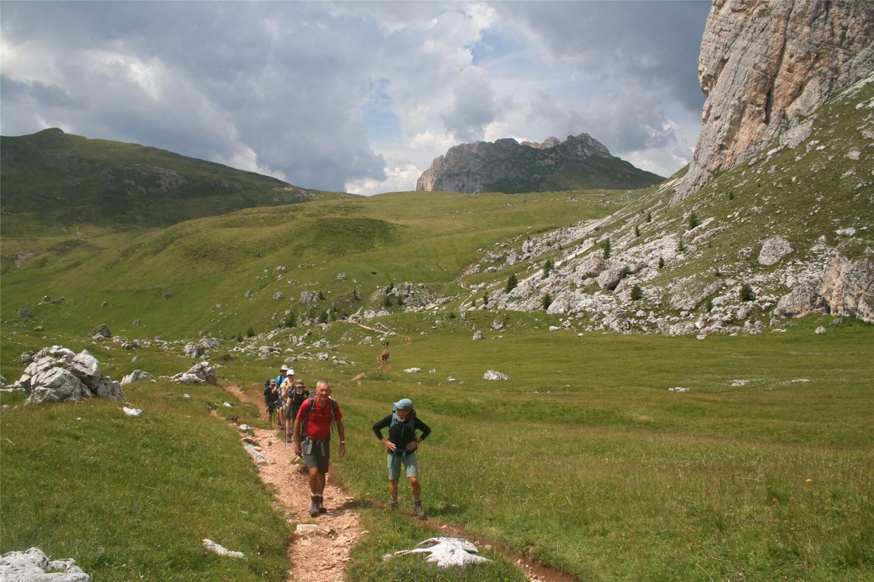 Hikers beneath Dolomite peaks