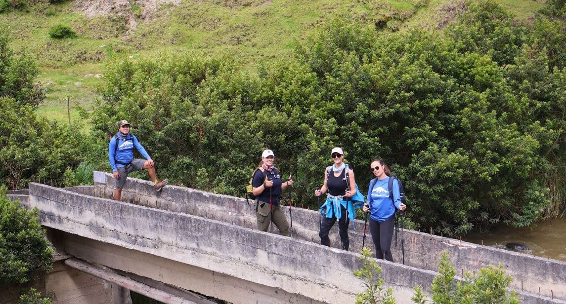 Hikers on a bridge in Ecuador