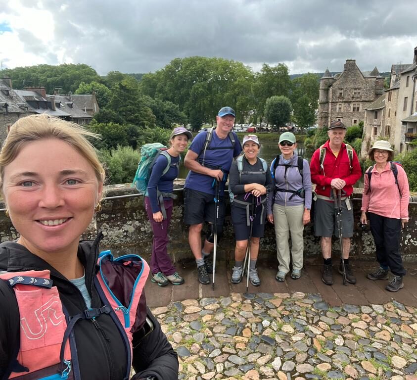 Hikers taking a selfie in Estaing along the Le Puy Camino in France