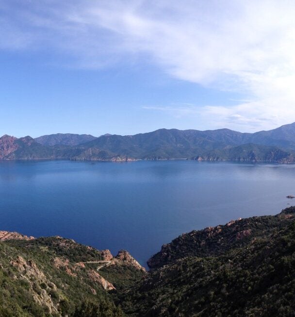 Female hiker above sea, Corsica
