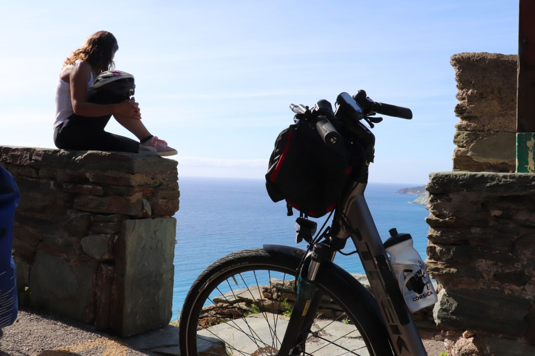 Rider on a viewpoint overlooking the sea on a break from the North Corsica bike holidays