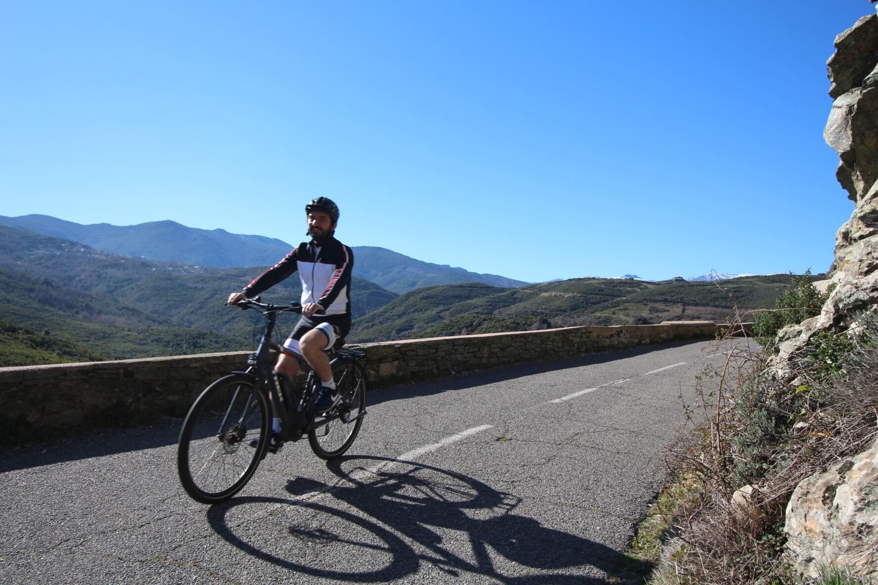 Rider on a road in mountainous North Corsica on bike holidays