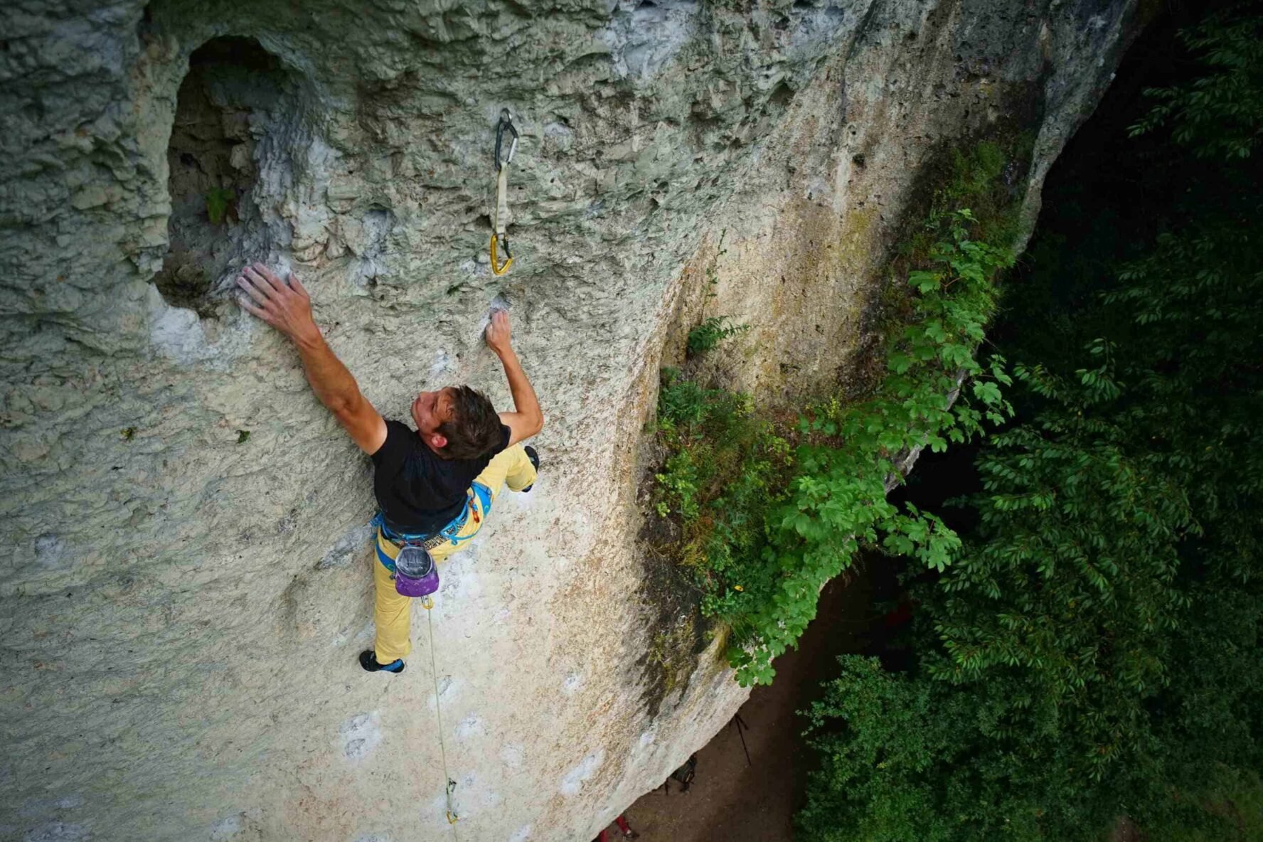 Rock climber on a high wall in Frankenjura