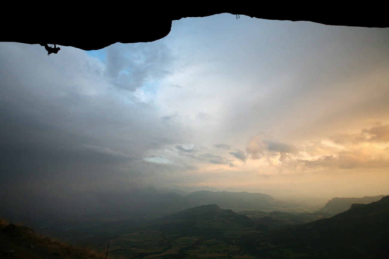 Rock climber on an overhang in Ceuse at sunset