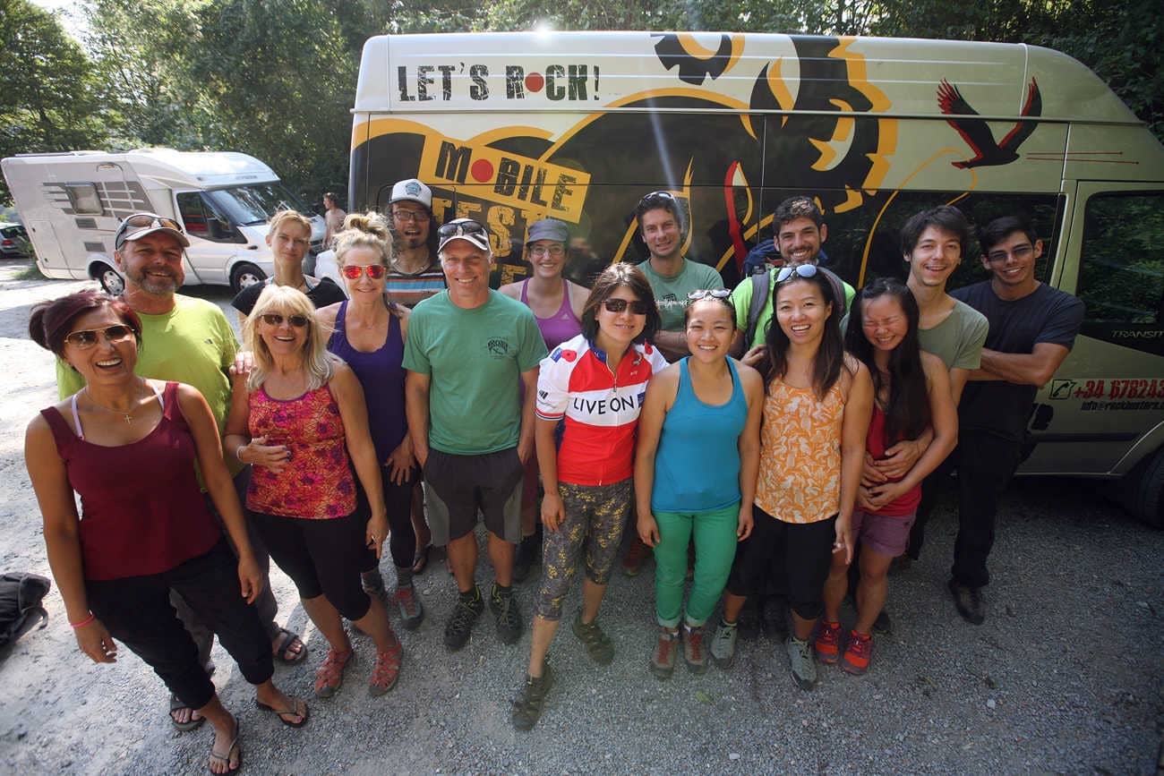 Rock climbing Europe group smiling in front of the van