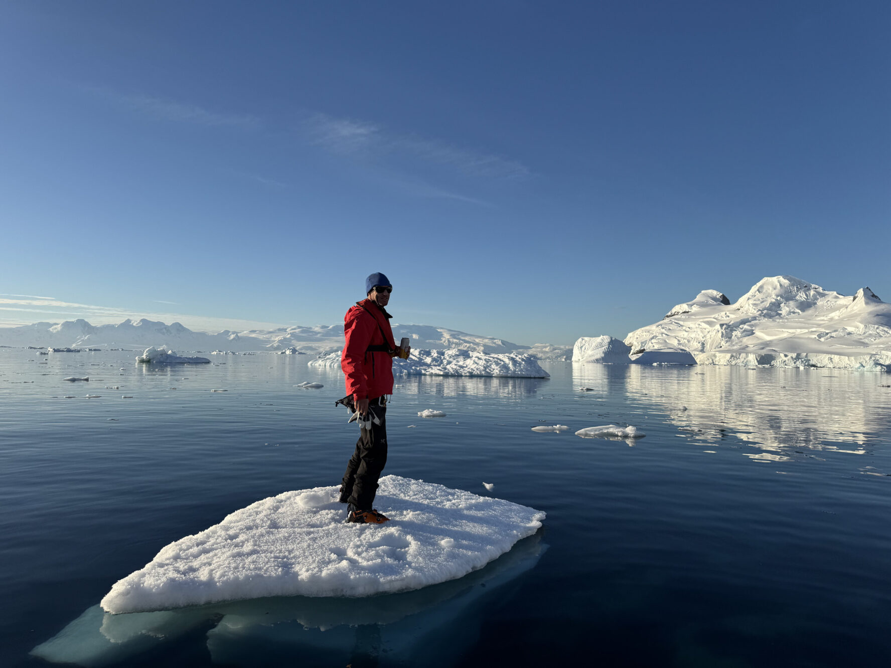Skier floating on a chunk of ice in Antarctica