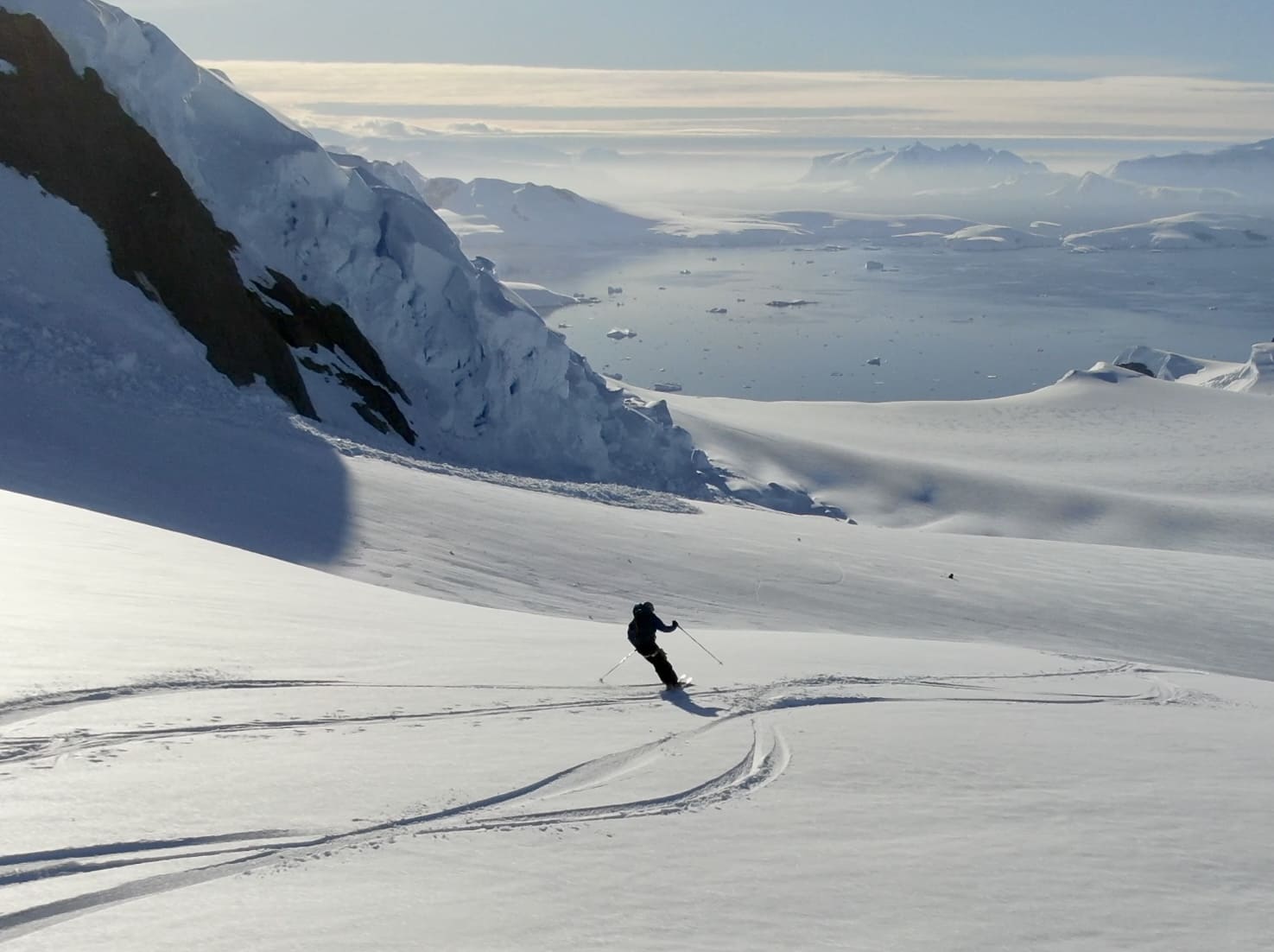 Skiing down a slope with sea views on the Antarctica adventure