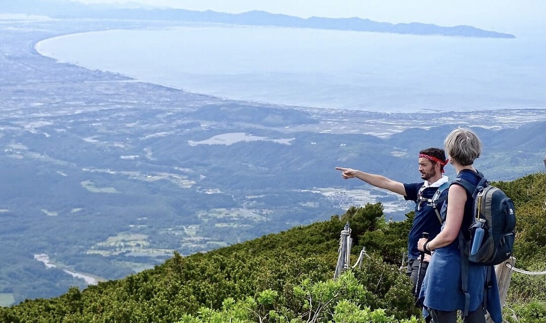 Two cyclists and panorama views in Japan