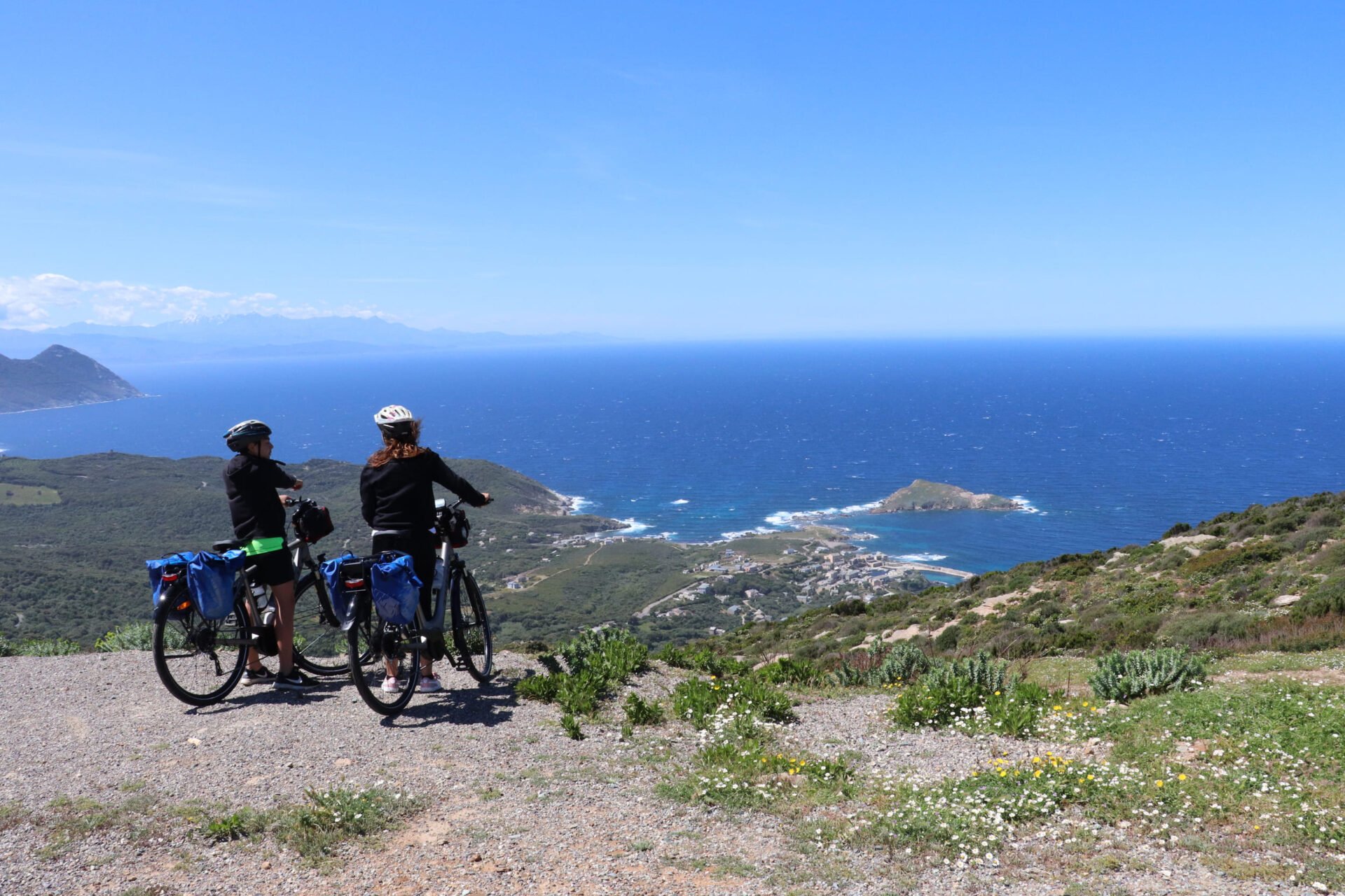 Two riders enjoying panoramic views of Centuri on the North Corsica bike holidays