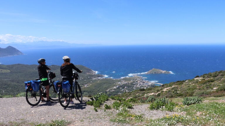 Two riders enjoying panoramic views of Centuri on the North Corsica bike holidays
