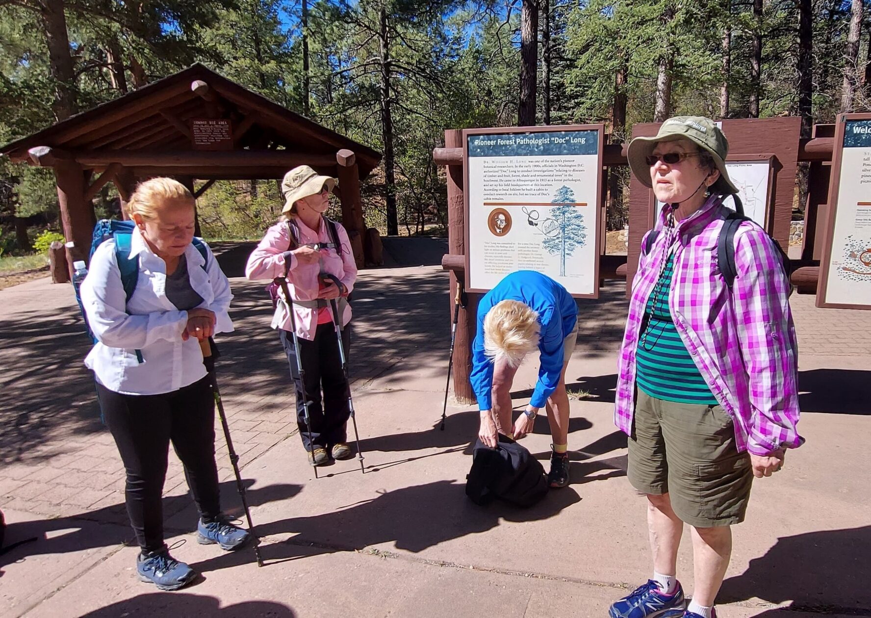 Women talking and preparing for a hike in the forest on the New Mexico tour