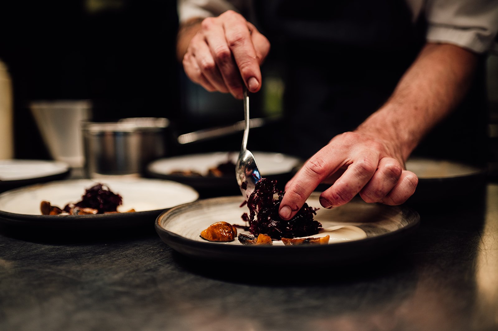 Chef plating a meal on the HMS Gassten