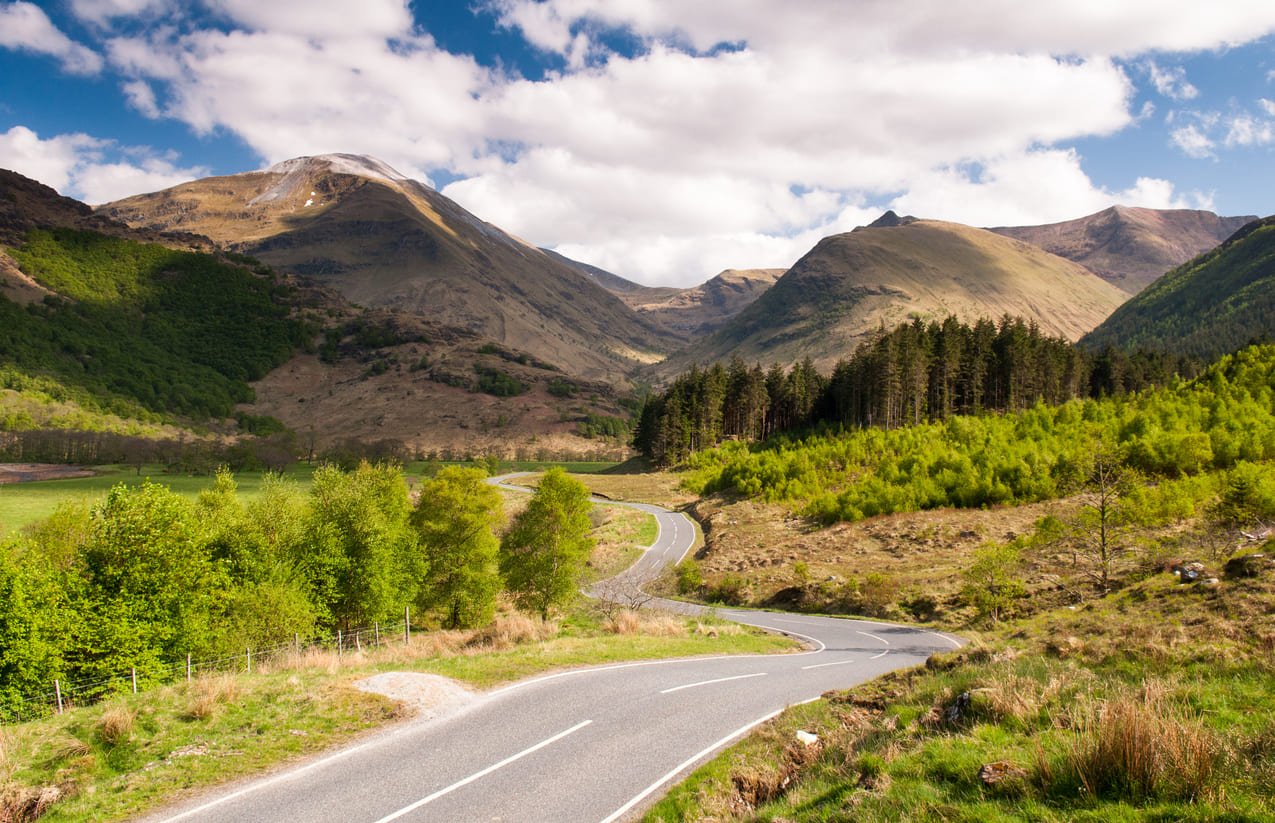Empty road through the Glen Nevis valley in the Highlands of Scotland