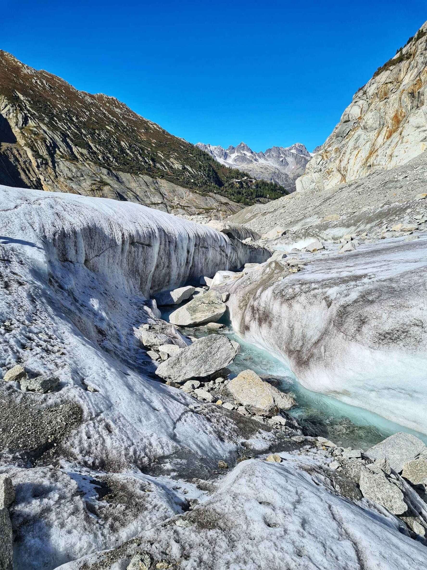 Glacial formations and mountain landscape on a sunny day at Mer de Glace