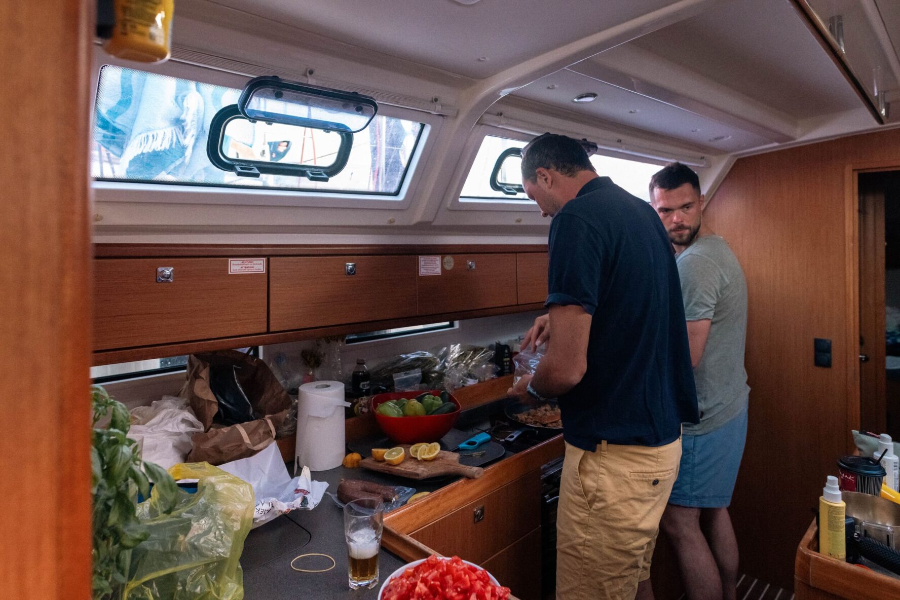 Group preparing a meal on the sailboat on the Greece freediving holiday