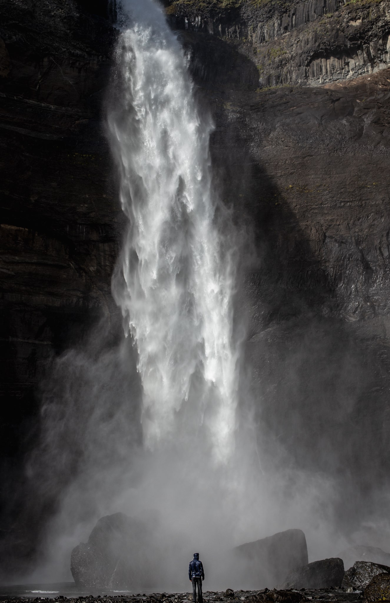 A hiker near the Haifoss Waterfall enjoying a Vista