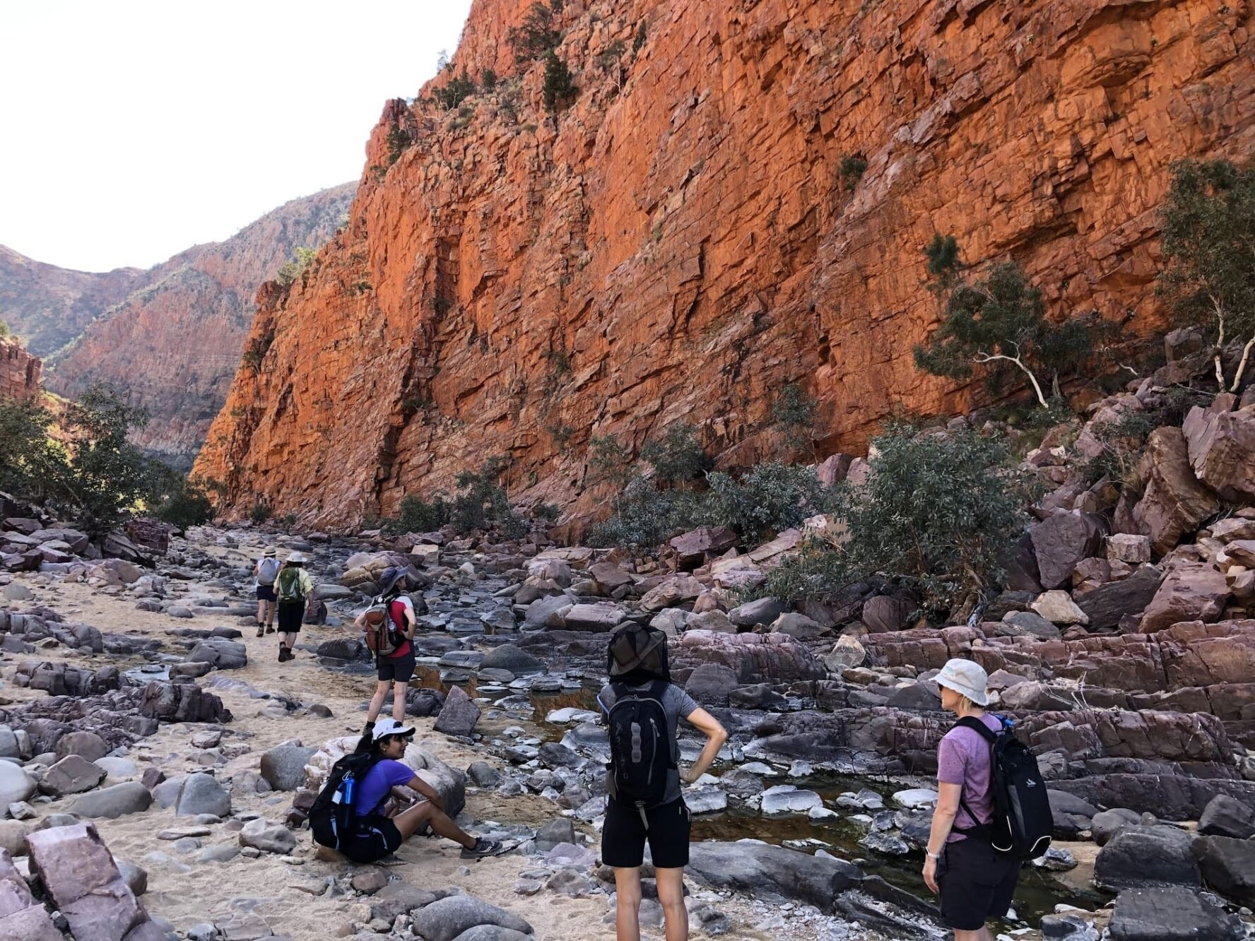 Hikers in front of a red wall