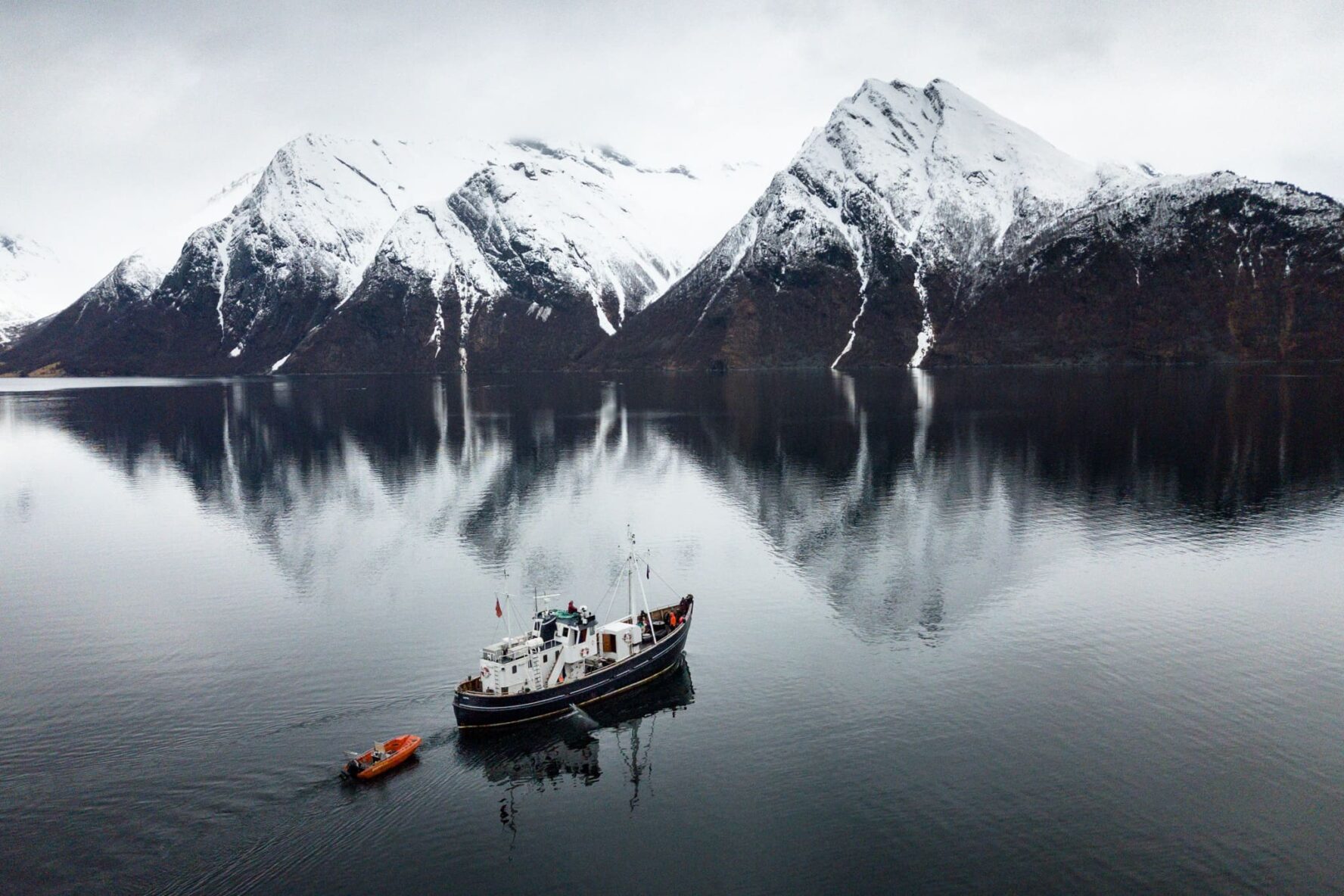 HMS Gassten anchored in a snowy landscape while sailing Lofoten