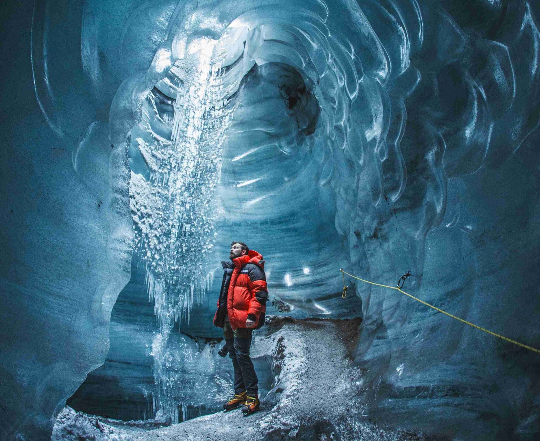 A hiker in the Katla Ice Cave in Iceland