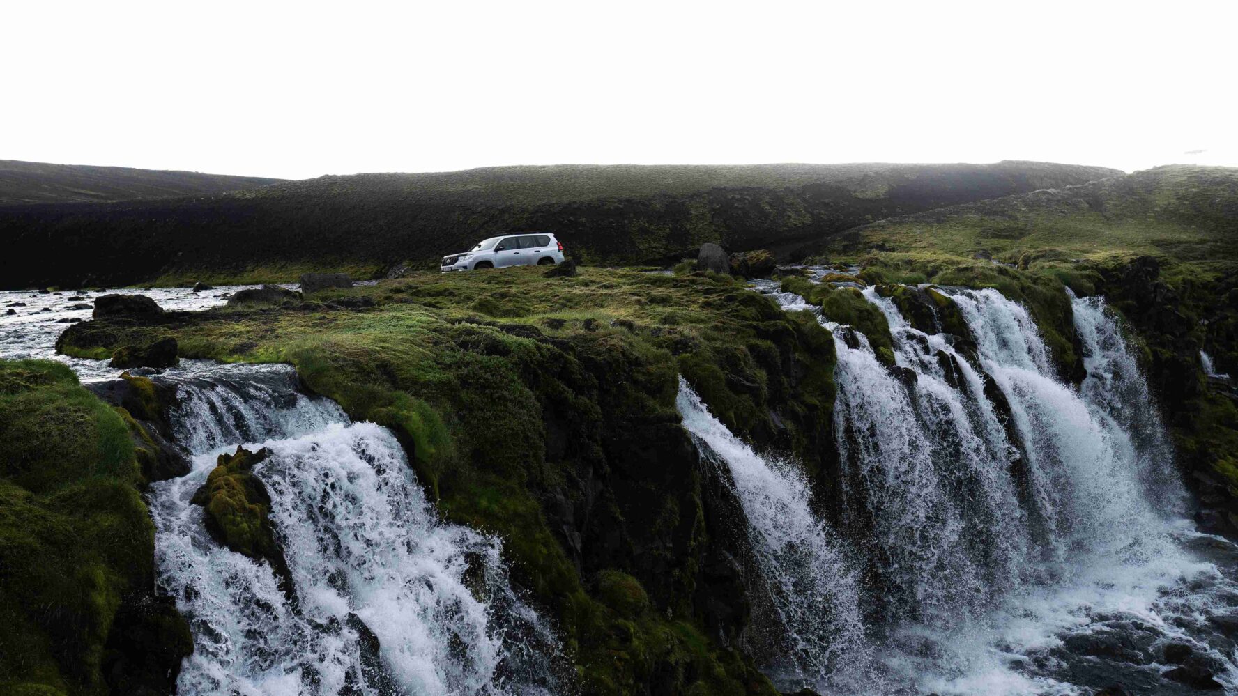 A truck near a waterfall in Maelifell, Iceland