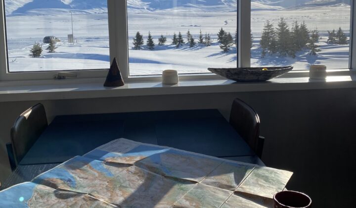 View of a mountainous landscape in North Iceland through the window over coffee