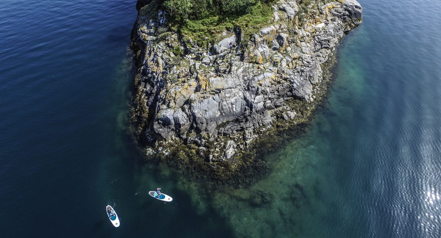 Aerial shot of paddleboarding while sailing Lofoten