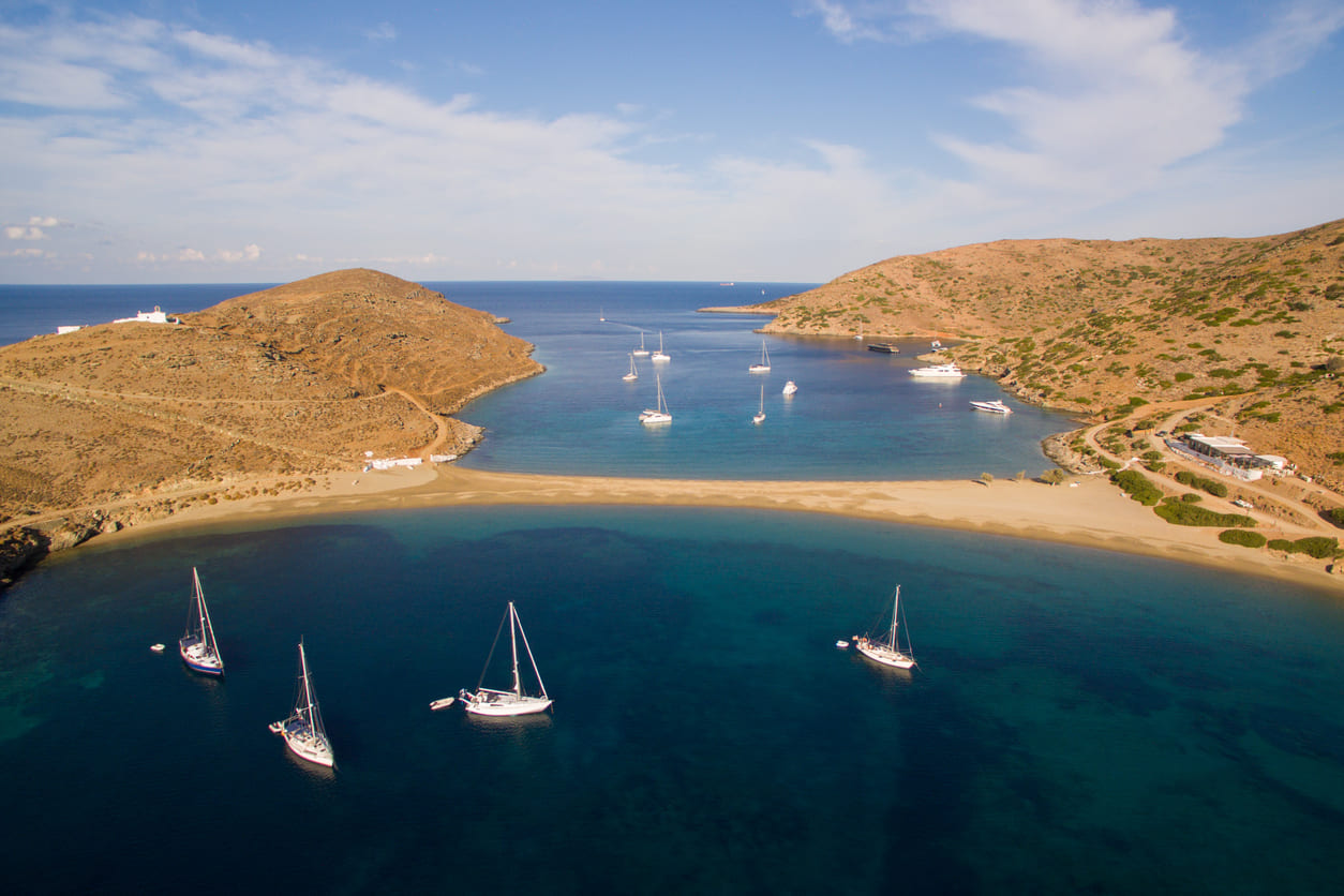 Sailboats anchored near Kolona beach in the Cyclades, Greece