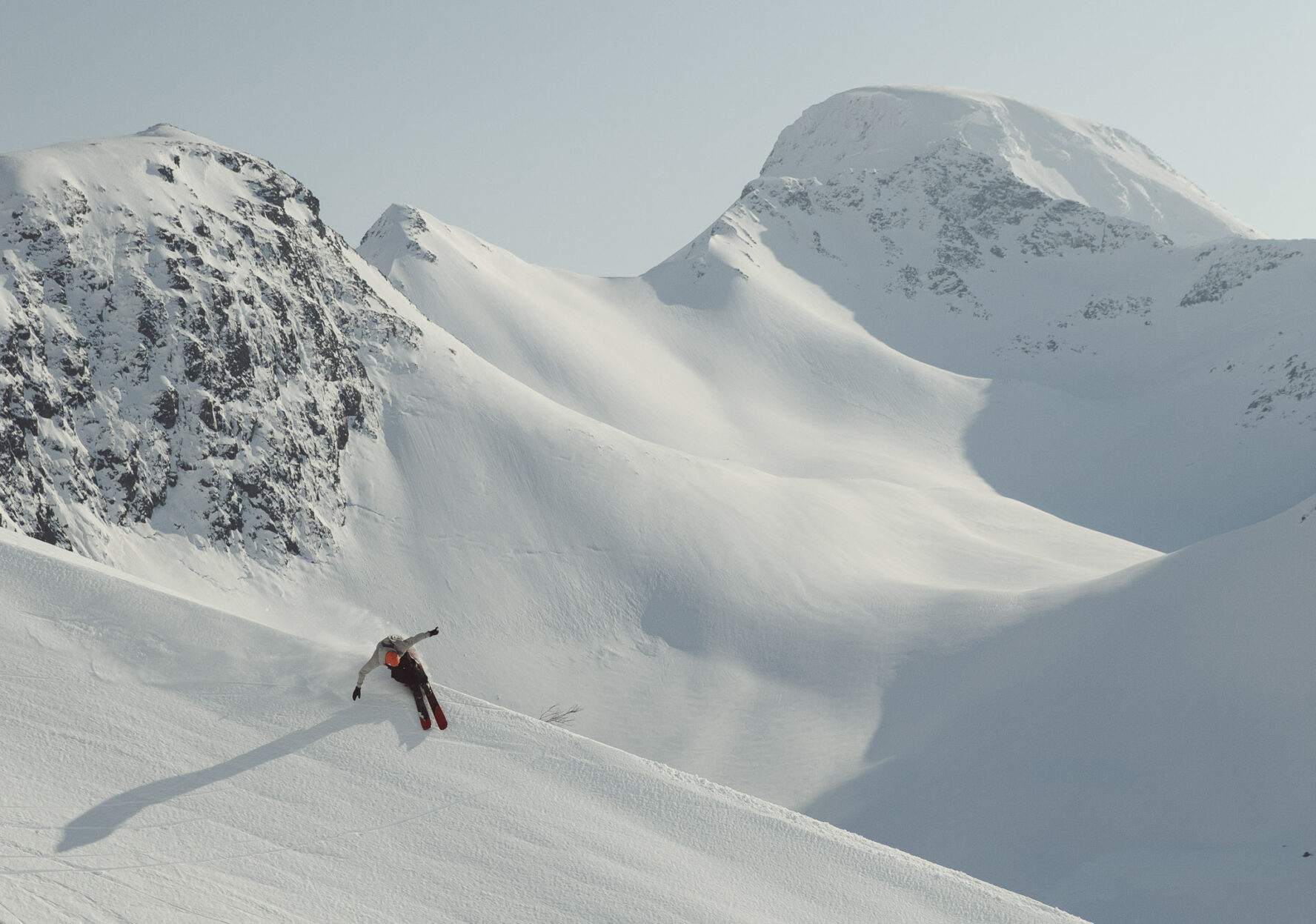 Skier carving through a snowy landscape in Lofoten