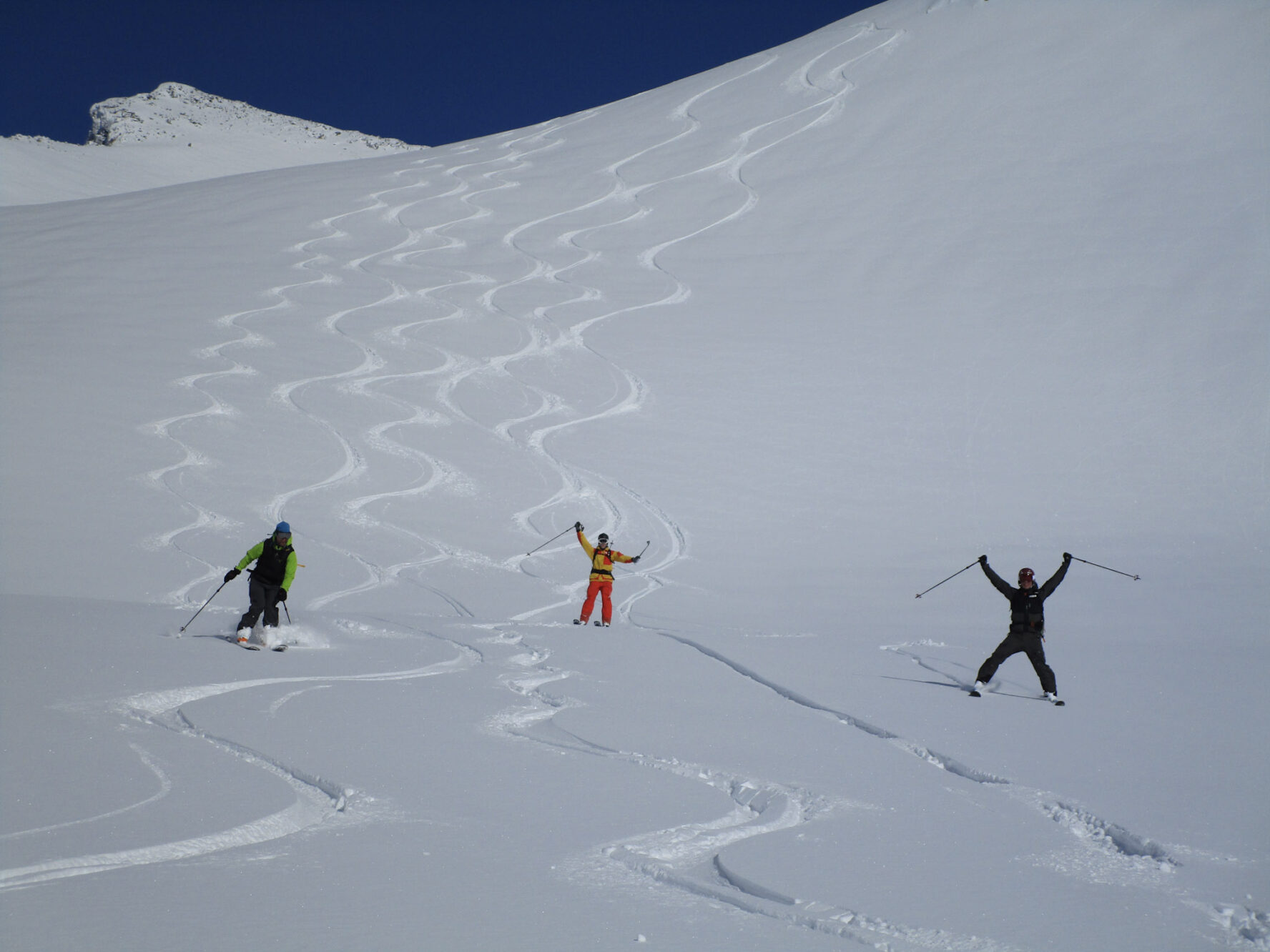 Skiers celebrating their descent in Lofoten