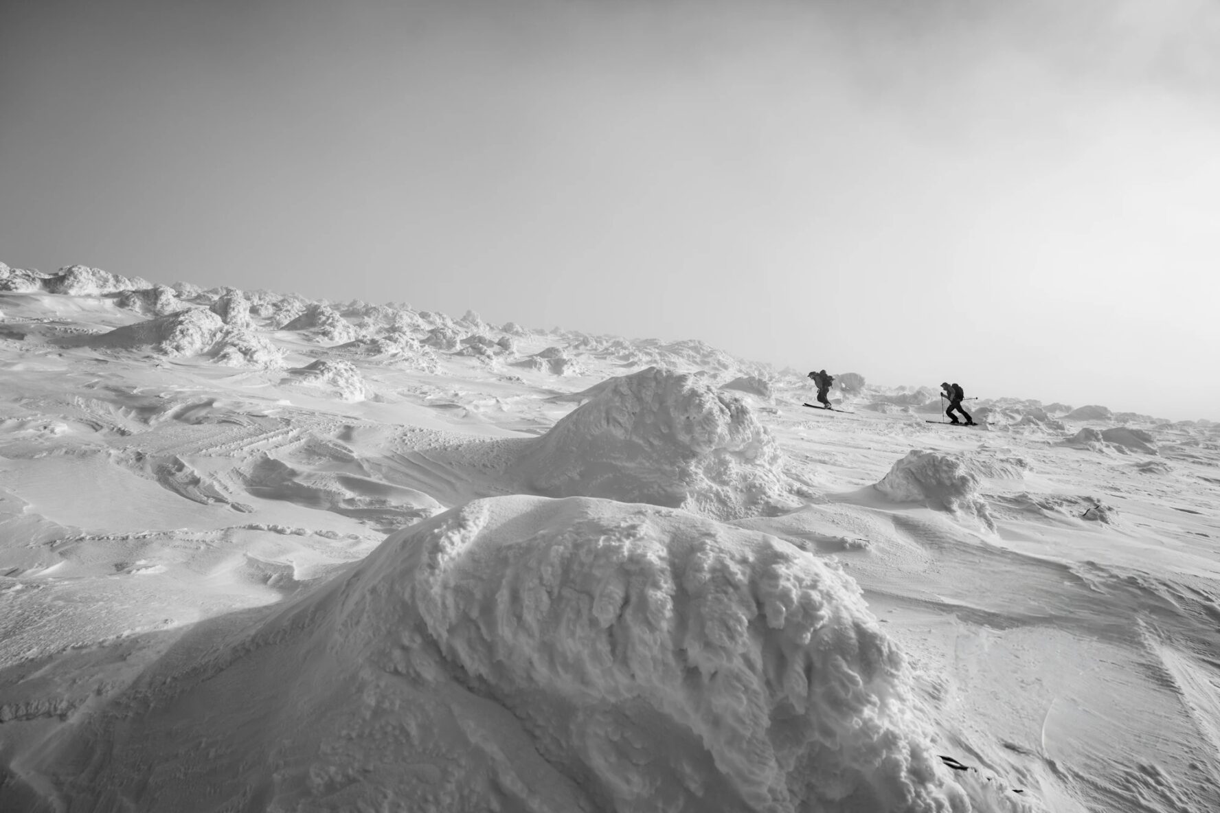 Skiers climbing uphill