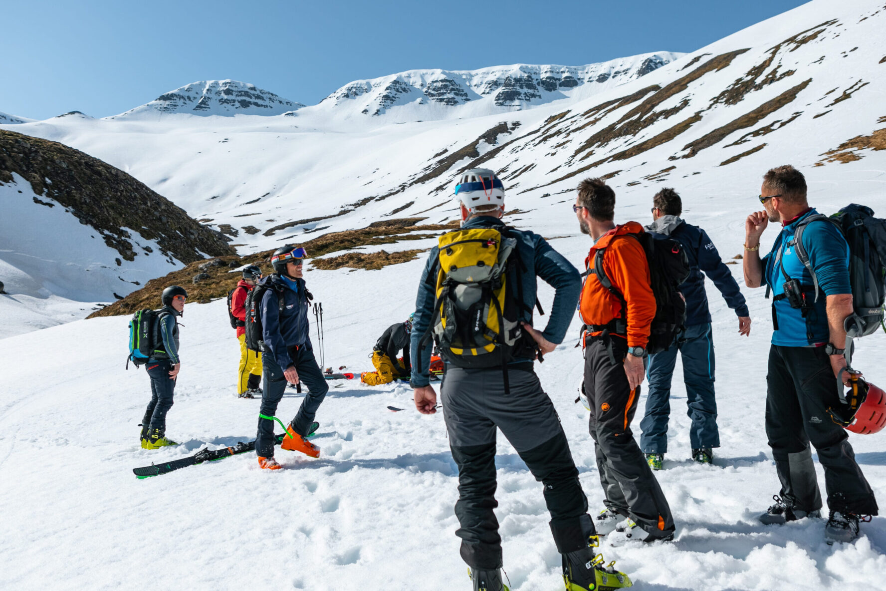 Skiing group on remote mountain terrain while Iceland heli touring