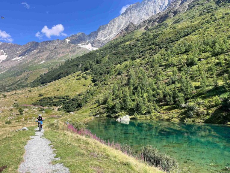 A bike rider near a lake in the Swiss Valais