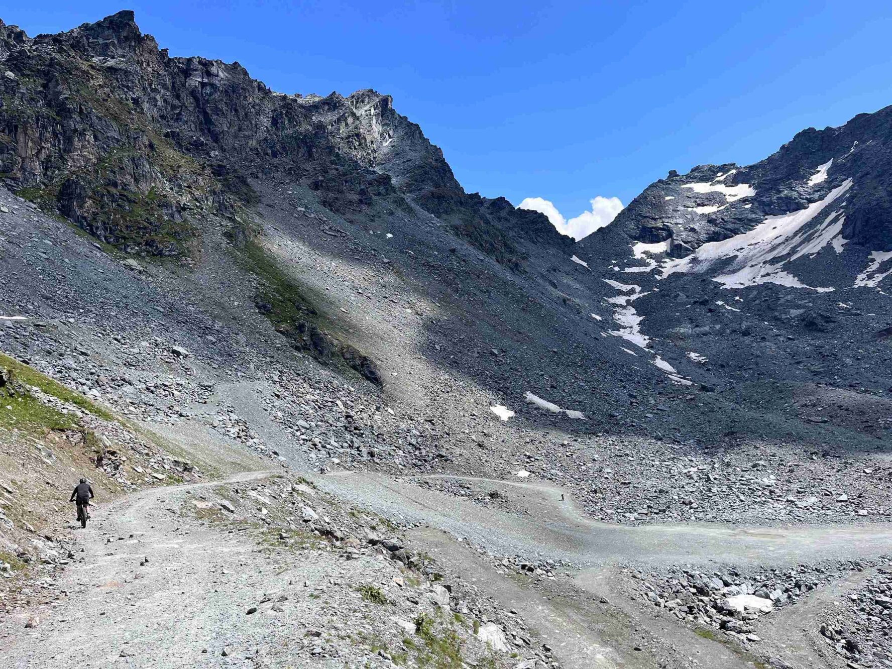 A biker riding near a mountain in the Swiss Valais