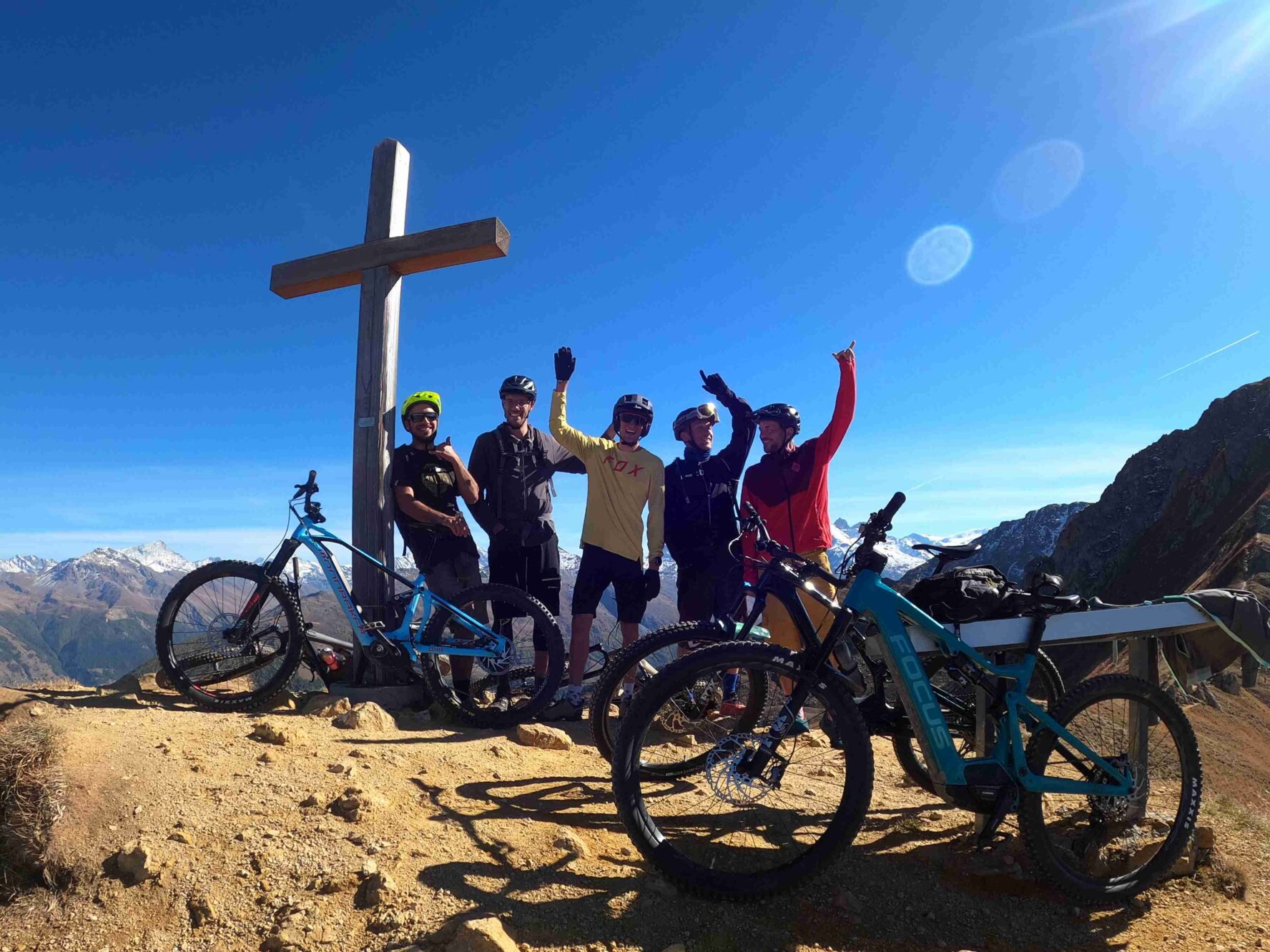 Bikers posing on a summit in the Swiss Valais