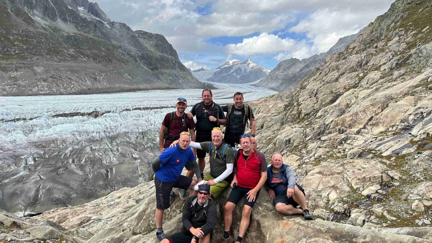 Riders posing by a glacier in the Swiss Valais