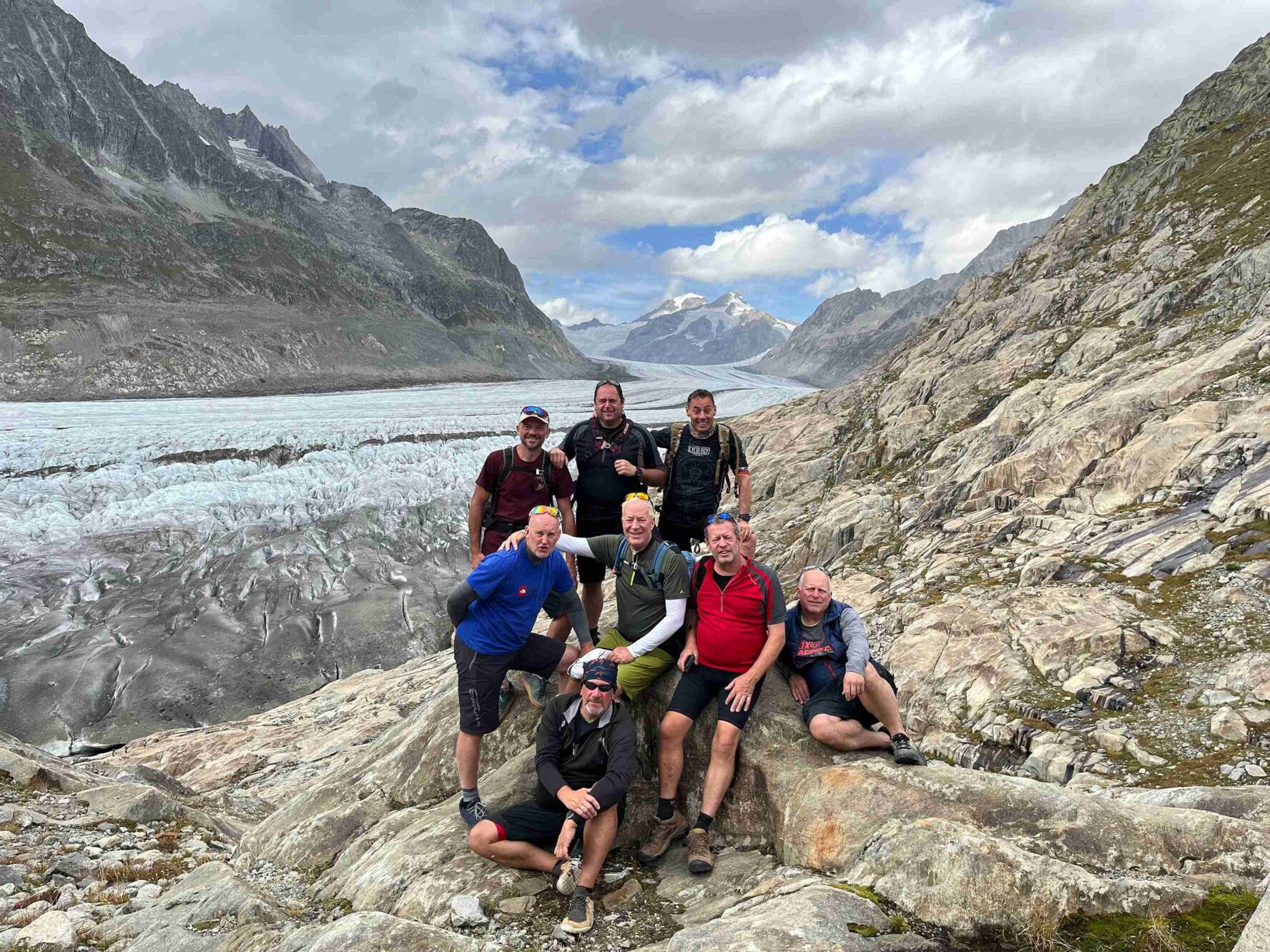 Riders posing by a glacier in the Swiss Valais