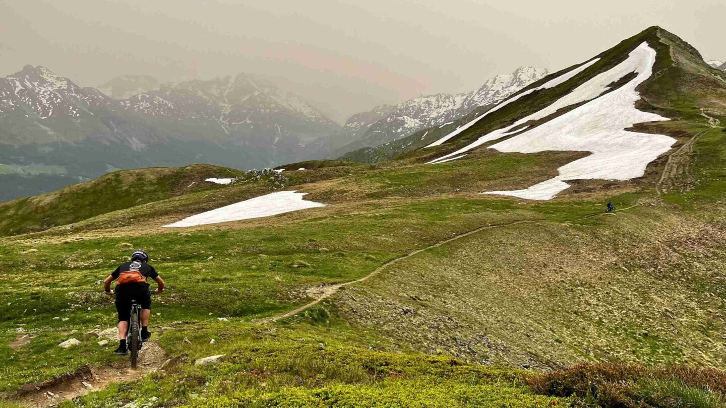 A snowy peak and a rider on the Swiss Valais