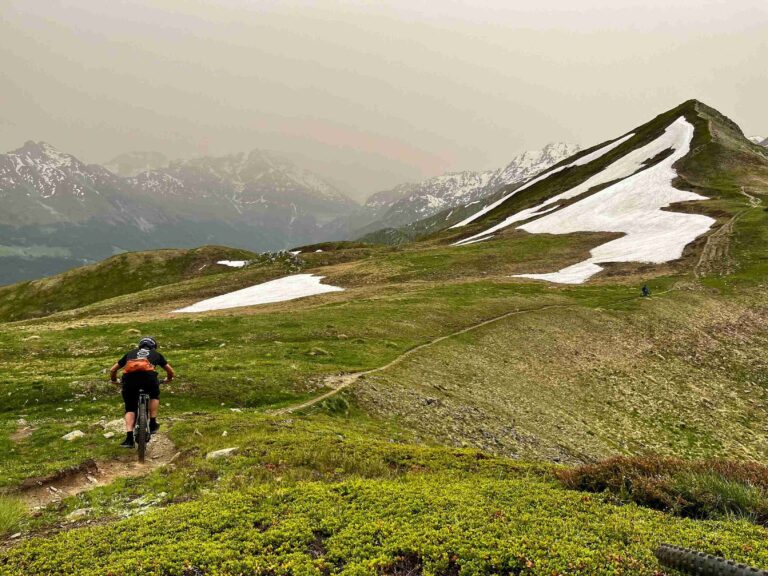 A snowy peak and a rider on the Swiss Valais