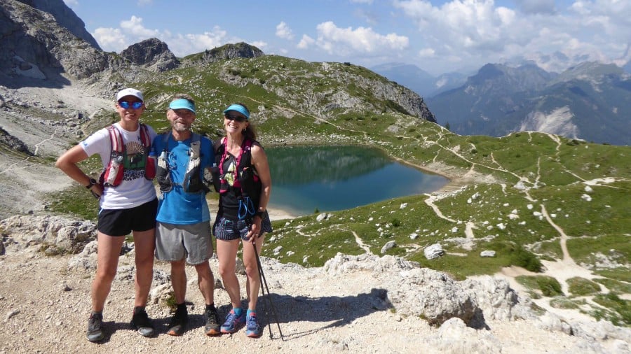 Trail runners above a lake on the Alta Via 1 trail run