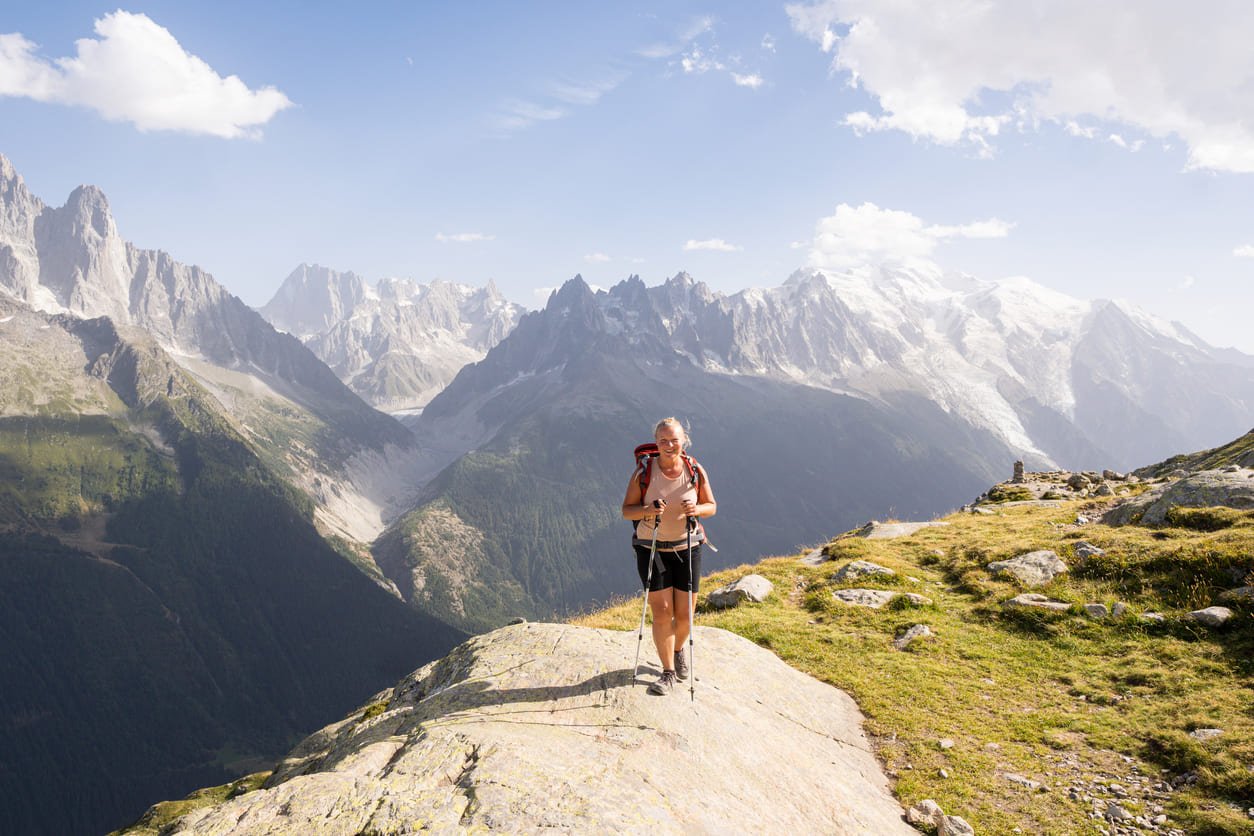 Woman smiling on a viewpoint with Mont Blanc in the background