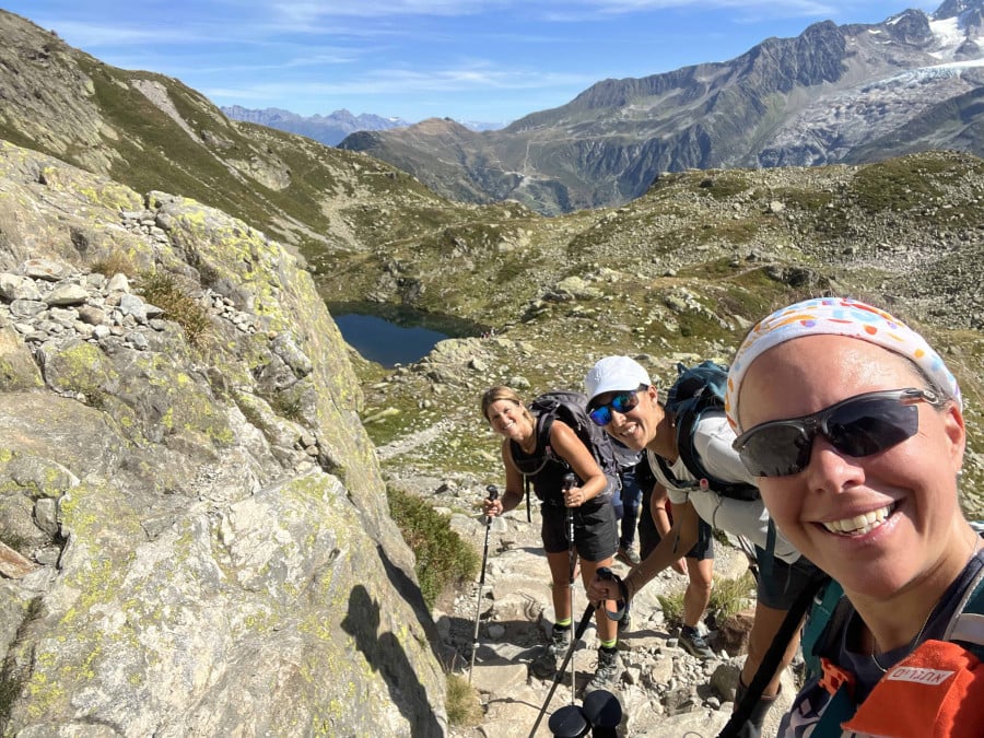 Women taking a selfie near a lake on the women-only Tour du Mont Blanc