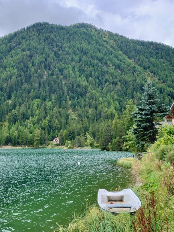 Champex lake with a boat along the shore in Switzerland