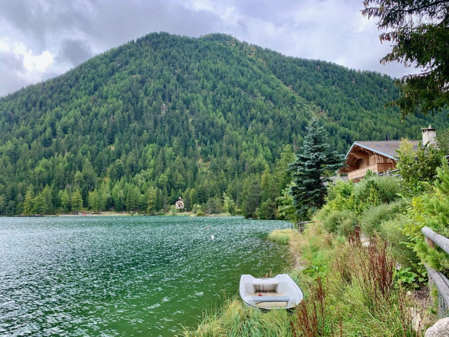 Champex lake with a boat along the shore in Switzerland