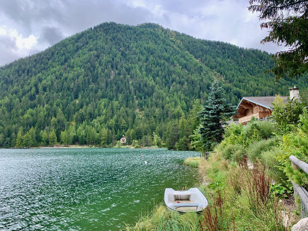 Champex lake with a boat along the shore in Switzerland