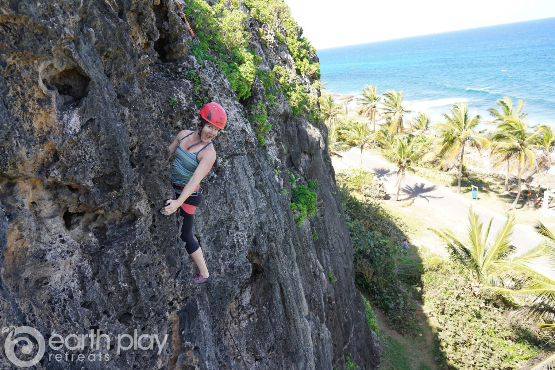 Woman climbing with palms in the background in Puerto Rico