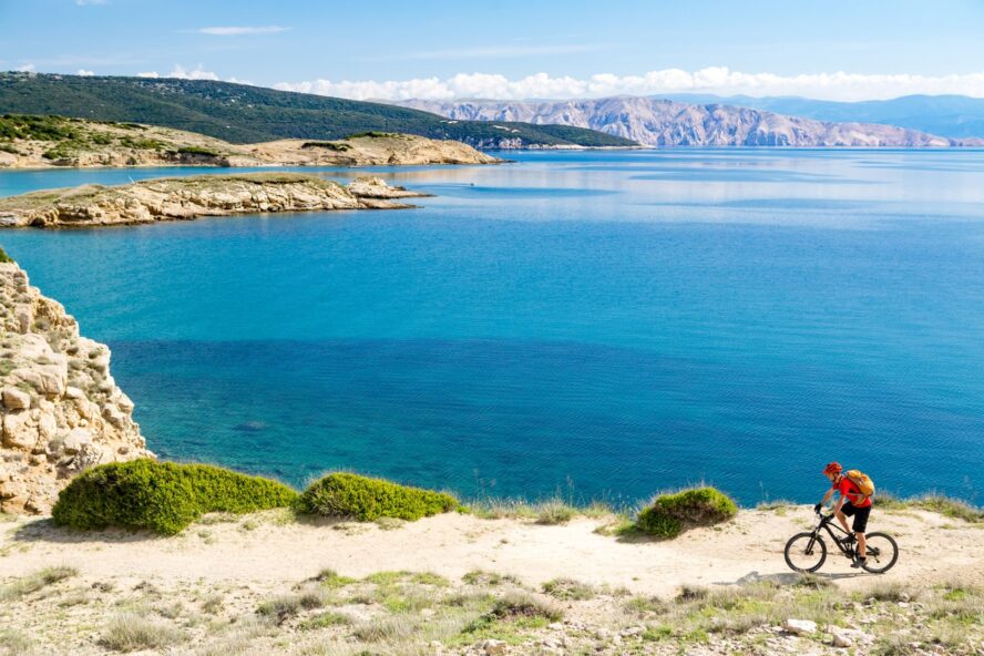 Biker in front of a seaside landscape in Croatia