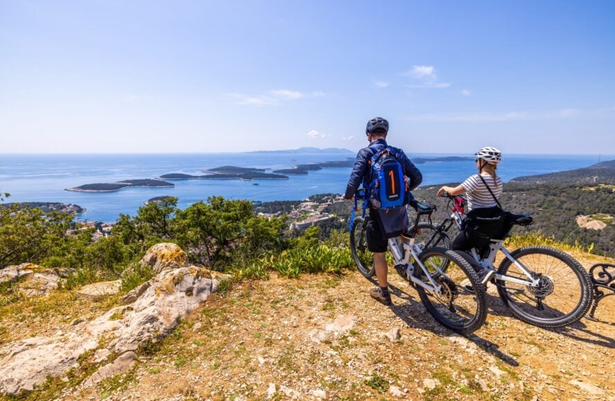 Man mountain biking in Hvar in a jacket in April - best time to visit Croatia