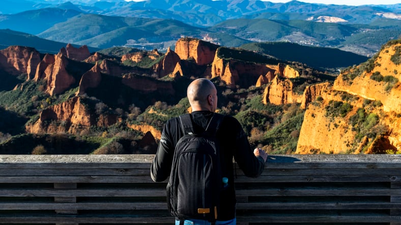 Man observes from a lookout point the natural park of Las Médulas, ancient Roman mines, León (Spain).