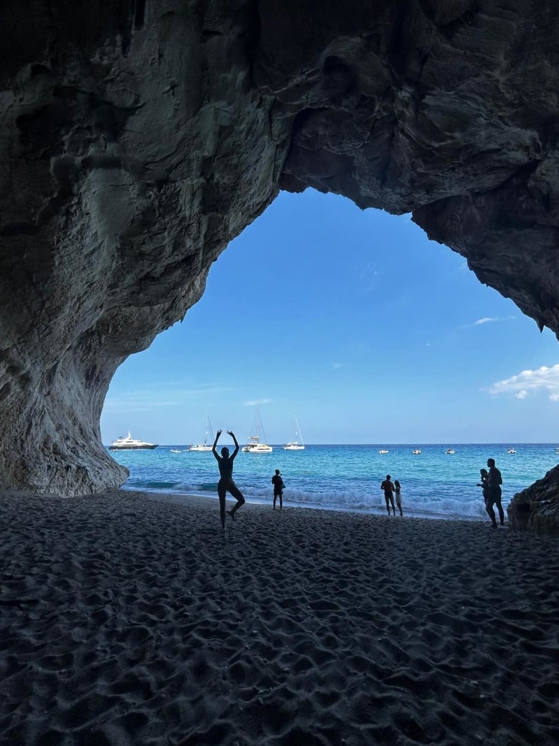 Cave in Sardinia and hikers